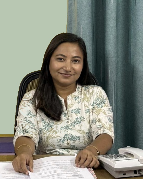 Anisha Maharjan smiling at her clinic desk