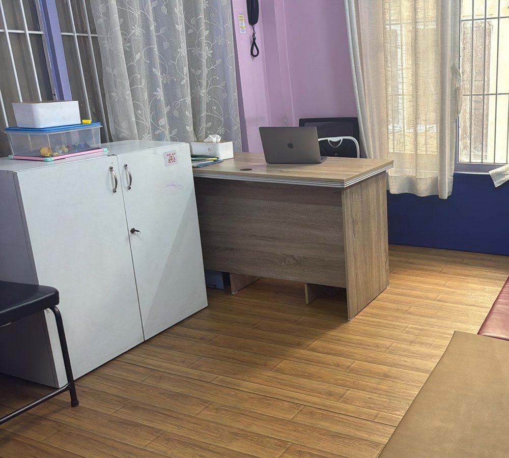 Therapy room with a padded play area, toys and space to move